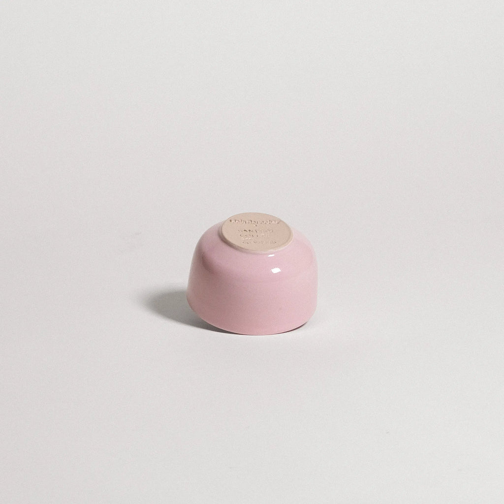 pink ceramic cup on a light gray background
