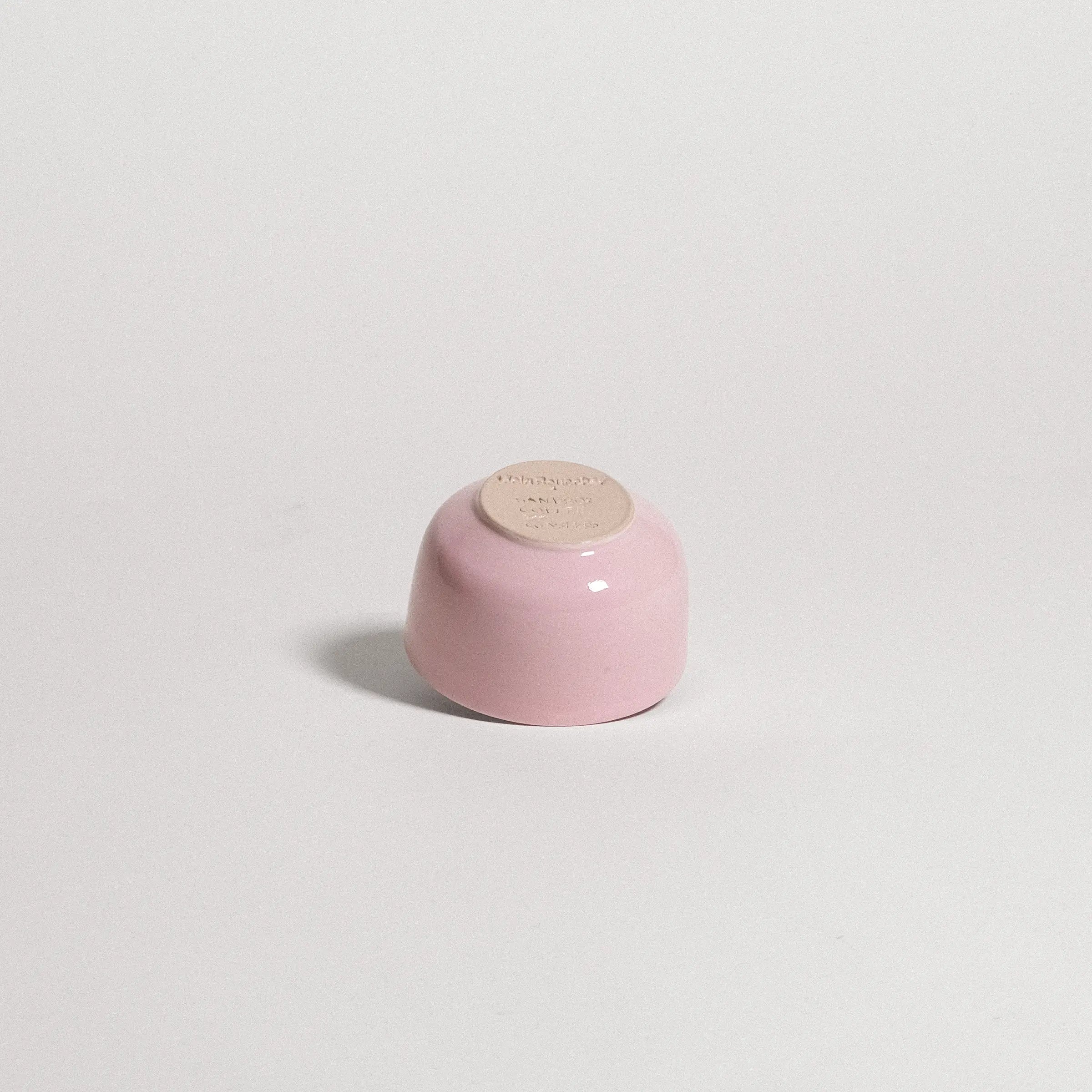 pink ceramic cup on a light gray background
