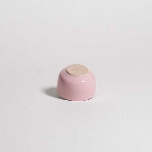pink ceramic cup on a light gray background